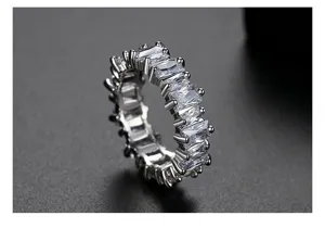 Detailweergave van rechthoekige zirkoniasteentjes op een elegante zilveren ringband