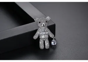Detailed macro view of a sparkling silver teddy bear brooch with rhinestone pavé
