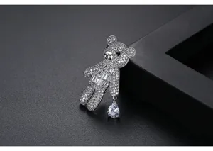 Exquisite teddy bear brooch with sparkling crystals and a pear-shaped drop pendant