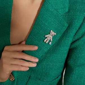 Sparkling full crystal teddy bear brooch for women, elegant fashion accessory on green blazer