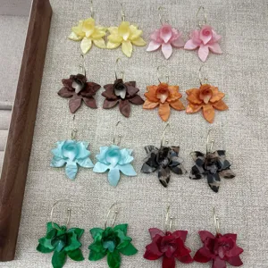Close-up view of elegant acrylic floral earrings in multiple vibrant colors