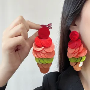 Detailed close-up showing colorful dopamine-style acetate disk fringe earrings on model.