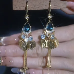 Elegant Korean style gold tassel earrings with shimmering blue teardrop crystals for women