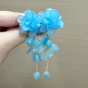 Elegant translucent blue floral dangle earrings featuring bell-shaped drops and gold chains