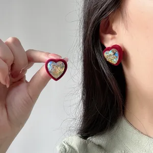 Elegant heart-shaped red velvet earrings with gold foil crystal detail and silver needle.