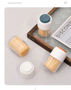 Detail view of portable toothpick dispensers with bamboo toothpicks on a wooden tray