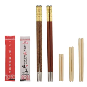 Reusable spliced bamboo chopsticks with replaceable heads and decorative gold handles.