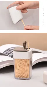 Macro view of a portable toothpick dispenser container filled with fine bamboo toothpicks.