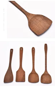Macro detail of natural wenge wood texture on long handle cooking spatulas