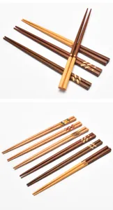 Detailed view of assorted Japanese-style wooden chopsticks with decorative inlaid patterns
