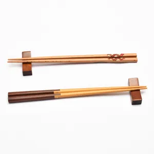 Japanese style wooden chopsticks sets with wooden rests on a clean white background.