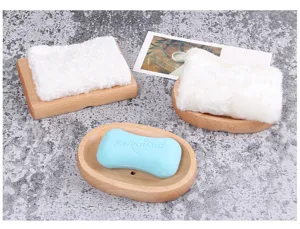 Detail showing textures of rectangular and oval wooden soap dishes with drainage holes