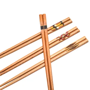 Handcrafted Japanese-style wooden chopsticks with geometric patterns for sushi dining