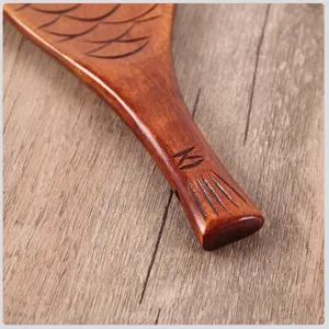 Fish-shaped wooden rice paddle made of Phoebe zhennan wood with carved scales.