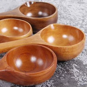 Set of handcrafted long handle wooden soup spoons with polished natural wood grain finish