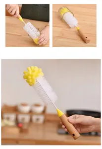 Detail of bottle brush with ergonomic wooden handle and dual sponge-bristle cleaning head