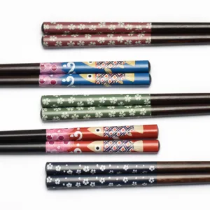 Set of five pairs of Japanese-style wooden chopsticks with colorful floral and fish prints
