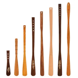 Collection of various length wooden shoehorns with decorative engravings