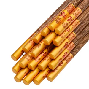 Elegante wengé houten eetstokjes met gouden doppen en een traditioneel Fu-patroon
