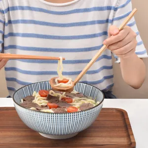 Long handle wooden ramen spoon for soup and noodles in lifestyle setting