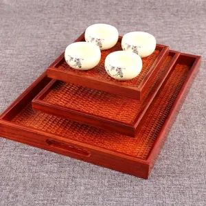 Traditional Japanese style wooden trays with rattan weave and white ceramic teacups