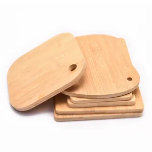 Set of natural bamboo cutting boards in various shapes and sizes for kitchen food prep