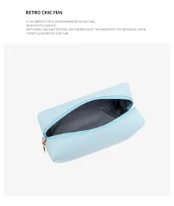 Detailed view of a light blue waterproof PU leather makeup bag with a gold zipper