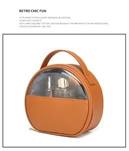 Detail view of round orange travel toiletry bag with clear PVC window and handle