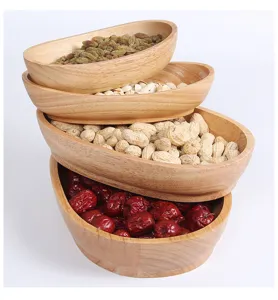 Detail of stacked boat-shaped wooden bowls filled with assorted nuts and dried fruits
