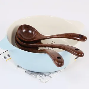 Set of three Japanese style long-handled Wenge wood soup spoons in a ceramic bowl