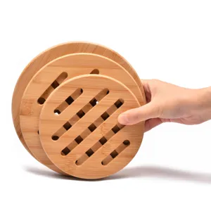 Set of three round hollow bamboo trivets for heat resistant table protection.