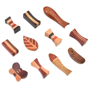 Set aus kreativen hölzernen Essstäbchenablagen in Blatt-, Fisch- und Schmetterlingsform
