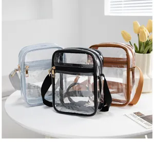 Detailed view of three transparent PVC crossbody bags in black, blue, and brown finish