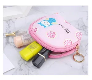 Detail showing storage capacity of pink owl mini coin purse with cosmetics inside