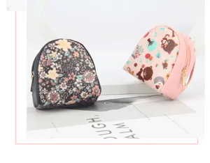 Macro detail of floral and pink cartoon animal mini shell-shaped coin purses with zippers.
