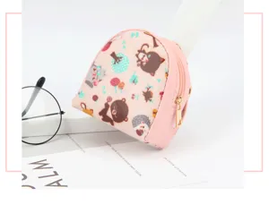 Detailed view of a mini shell-shaped coin purse featuring cute cartoon animal prints