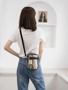 Model back view wearing a transparent PVC waterproof crossbody bag with cosmetics inside