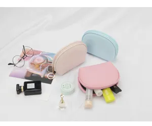 Details of semi-circle makeup bags in pink, blue, and beige with waterproof material