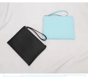 Detail view of black and light blue waterproof PU leather wristlet cosmetic pouches