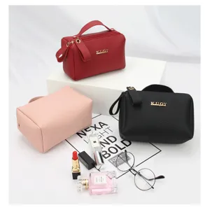 Portable pebbled leather makeup bags in red, black, and pink colors for travel