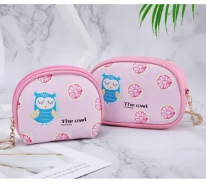 Detailed view of cute pink owl coin purses with grapefruit pattern and zipper closure