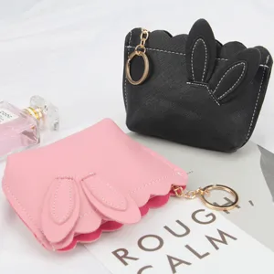Cute rabbit ear shaped coin purse featuring gold keyring and decorative wavy edge design