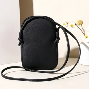 Minimalist black crossbody phone bag with cross-hatch texture for daily travel and commute