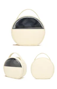 Professional multi-angle view of a cream round travel makeup bag with a clear PVC window