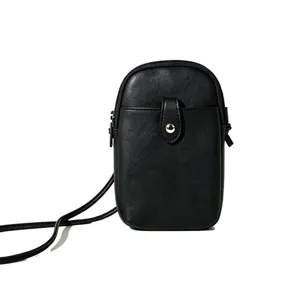 Minimalist black leather crossbody phone bag with snap button closure and slim strap.