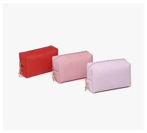 Detail view of colorful waterproof PU leather cosmetic bags in red, pink, and purple