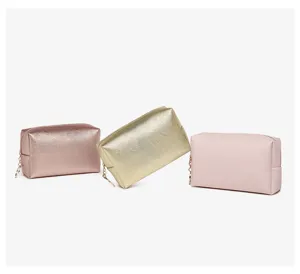 Detailed view of PU leather makeup bags in metallic gold, rose gold, and soft pink.