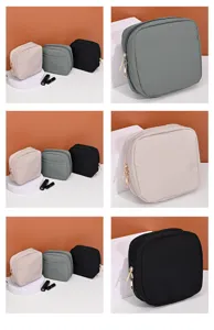 Detailed macro view of portable square cosmetic storage bags in beige, green and black