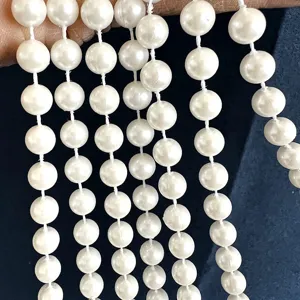 Close-up of 10mm white faux pearl bead chain for wedding DIY jewelry accessories