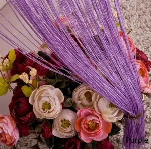 Close-up detail of purple string curtain showing fine texture and vibrant color for room partition